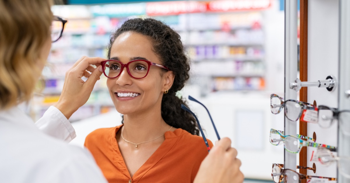 Eye doctor helping client choose glasses