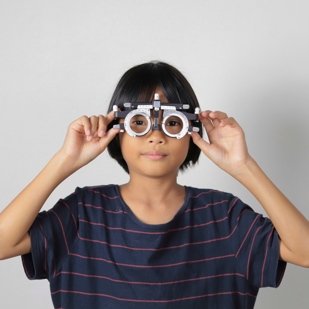 Boy holding eye examining tools