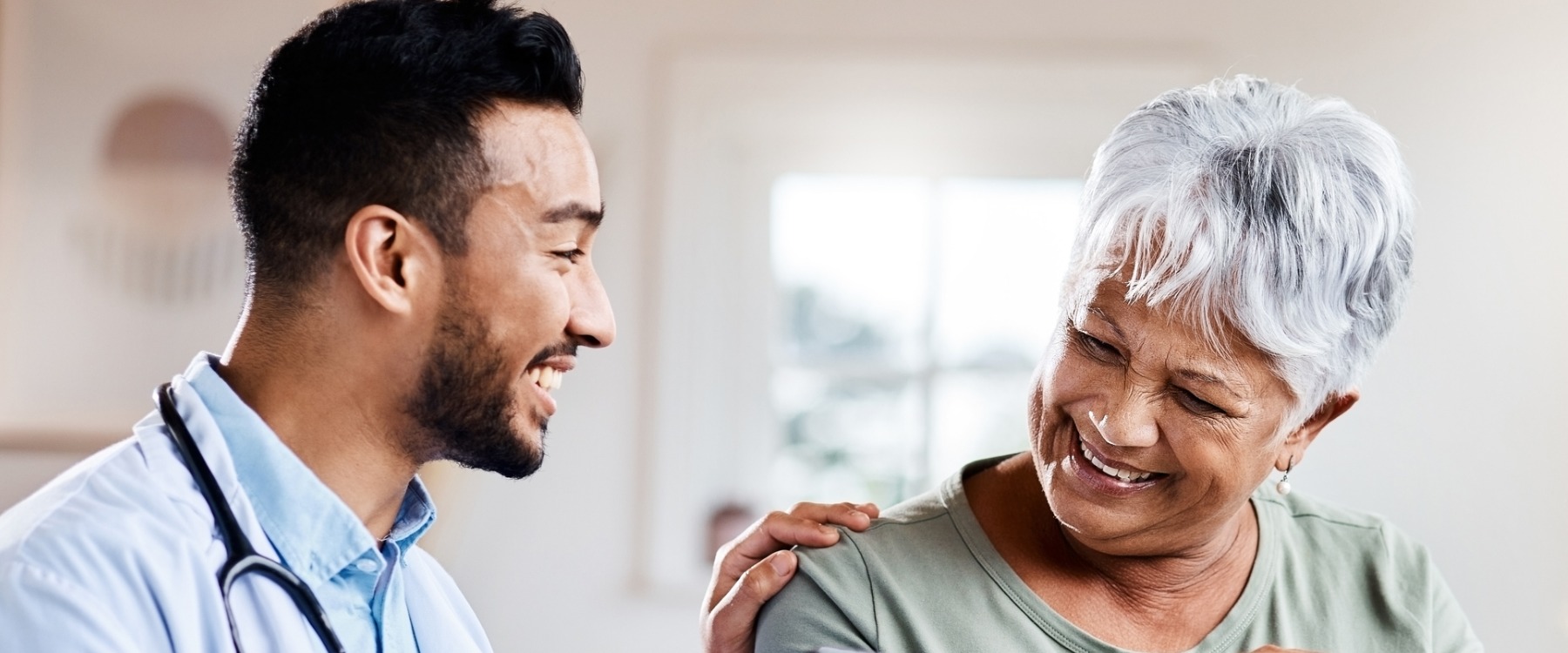 Young doctor and older patient smiling