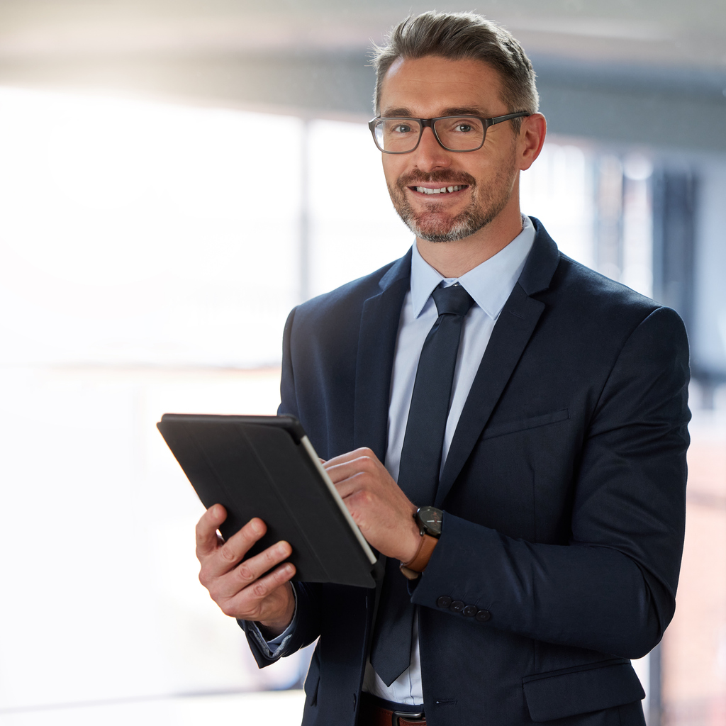 Portrait of a businessman using a digital tablet at the office