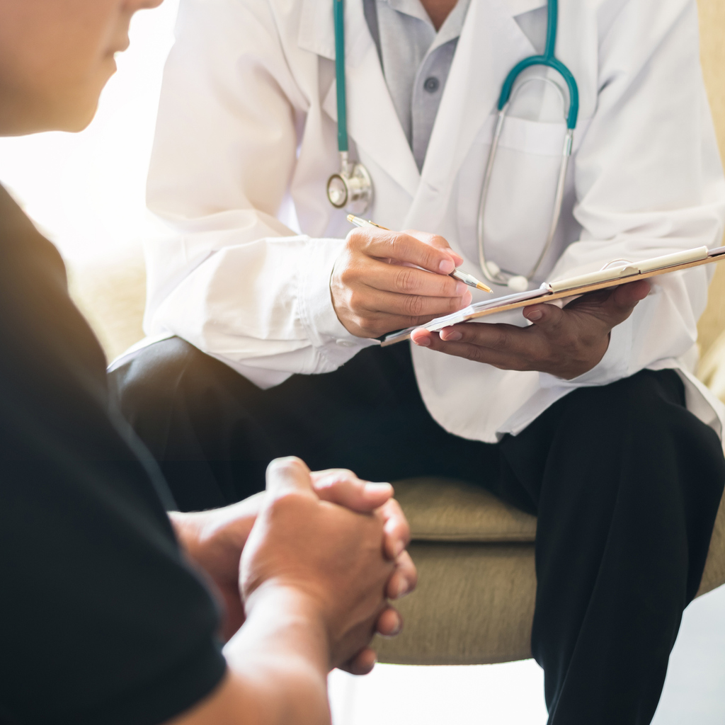 Doctor consulting male patient