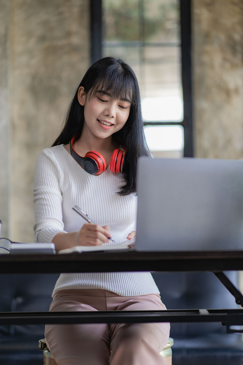 cheerful asian woman working at desk