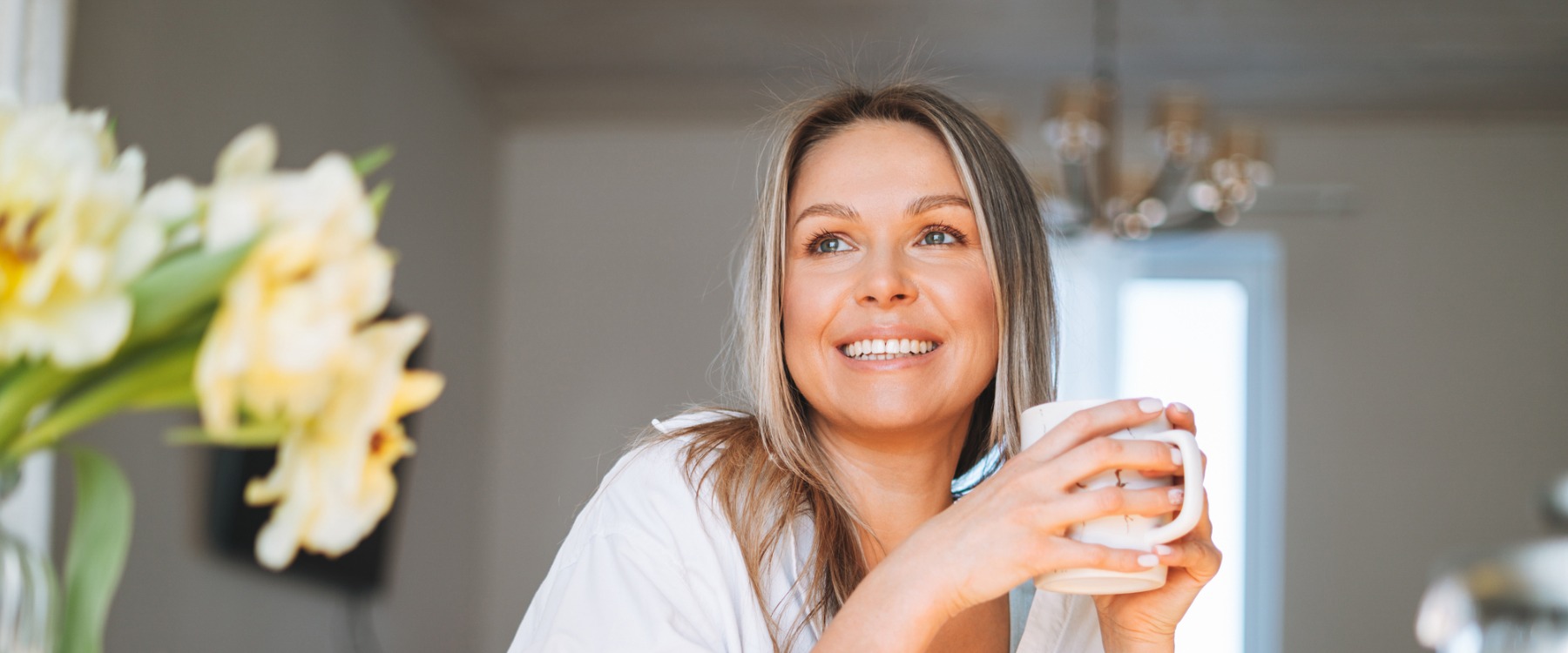 Young woman smiling drinking tea