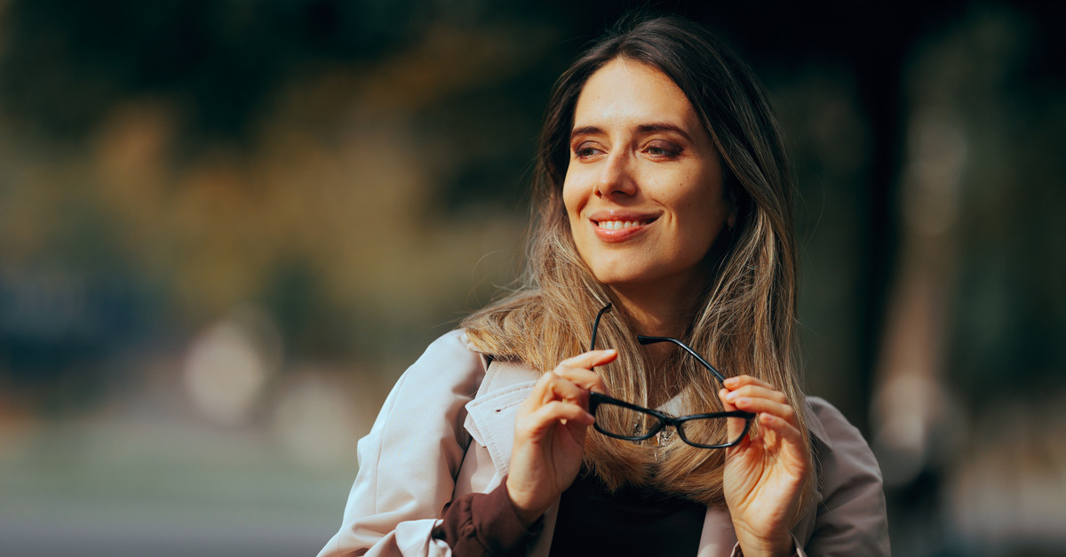 Happy woman holding glasses